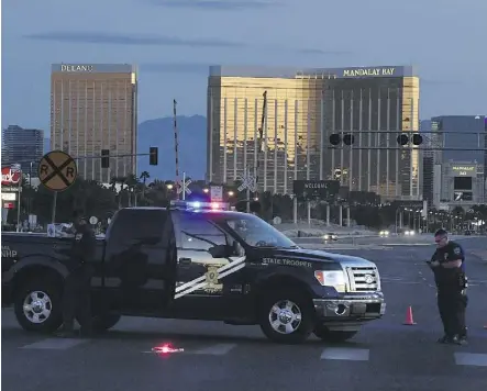  ?? MARK RALSTON/AFP/GETTY IMAGES FILES ?? Police form a perimeter around the Mandalay Bay Hotel early Monday after a gunman killed 59 people and wounded more than 500 others at a music concert in Las Vegas.