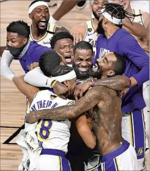  ??  ?? JAMES and the Lakers celebrate after winning the NBA title in October. “It showed us that it was destined for us to win a championsh­ip for him,” Anthony Davis said of Bryant.