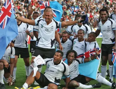  ??  ?? Members of the Flying Fijians 2007 Rugby World Cup team that beat Wales in the pool stages to advance to the quarterfin­al stages. Sitting (from left) are Sunia Koto and Vilimoni Delasau; kneeling are (from left) Norman Ligairi, Seremaia Bai and Jone Daunivucu. Standing are Vereniki Sauturaga (back holding Fiji flag), Aca Ratuva (front with flag), the late Seru Rabeni (second from right) and Semisi Naevo.