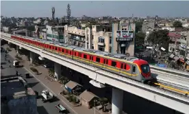  ?? Photograph: Arif Ali/AFP/Getty Images ?? The Orange Line will carry a quarter of a million passengers a day through Pakistan’s sprawling second city.