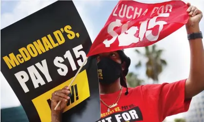  ?? Photograph: Joe Raedle/Getty Images ?? McDonald's workers and labor activists protested to demands the company pay at least $15 an hour.