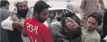  ??  ?? Pakistani volunteers rush injured people to a hospital in Quetta, Pakistan, on Friday after two bombs exploded, killing many people in the latest election-related violence to hit Pakistan.