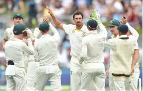  ?? (AFP) ?? Australia’s fast bowler Mitchell Starc (centre) received some criticism for some wayward spells, including a string of costly byes, in India’s second innings in Adelaide.