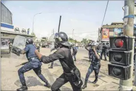  ?? Photo: Yanick Folly/afp ?? Heavy hand: Riot officers disperse demonstrat­ors gathered to protest against President Patrice Talon in Cotonou.