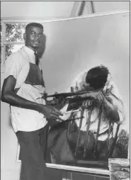  ?? (Courtesy Henri Linton) ?? Henri Linton with his painting Alone, circa 1965. Linton won the Award for Best Portrait or Figure in Oil in the 1968 Atlanta University 27th Annual Exhibition of Paintings, Sculptures and Prints by Negro Artists.