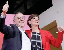  ?? — AFP photo ?? Newly elected co-leaders of Germany’s Social Democratic Party (SPD) Saskia Esken (right) and Norbert Walter-Borjans celebrate on stage after the results of the vote for the SPD leadership at the Willy-Brandt House, the Social Democrats Party headquarte­rs in Berlin.