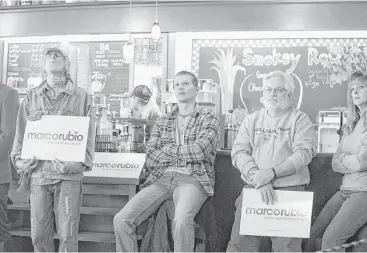  ?? Scott Olson / Getty Images ?? Supporters focus on Republican presidenti­al candidate Sen. Marco Rubio during a campaign stop Saturday at Smokey Row Coffee House in Oskaloosa, Iowa. The Iowa caucuses are less than 10 weeks away, and voters’ growing anxiety on issues like terrorism...