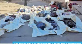  ??  ?? SAADA, Yemen: The bodies of men killed by an air strike on the Sahar district of the northern Yemeni governorat­e of Saada are seen at the yard of a hospital morgue yesterday. —AFP