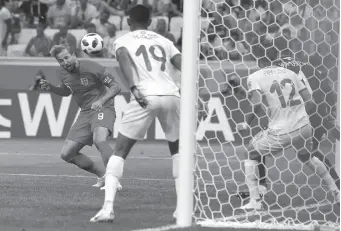  ?? AP PHOTO ?? England’s Harry Kane scores the game-winner against Tunisia during a Group G match at the World Cup in Volgograd, Russia, on Monday.