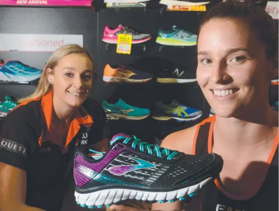  ??  ?? Townsville Fire players Darcee Garbin and Kayla Standish check out the stock at The Athlete's Foot at Willows.