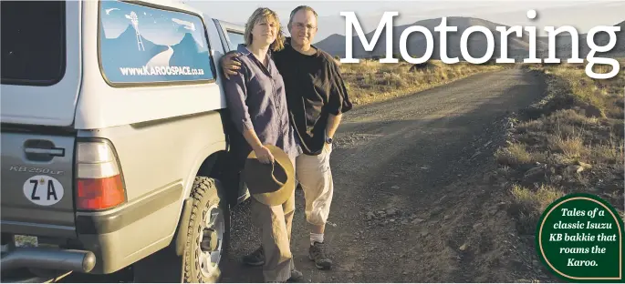  ??  ?? OFF THE BEATEN TRACK. Photojourn­alists and authors Chris Marais and Julienne du Toit on a Karoo back road in their old Karoo Space colours.