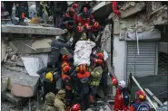  ?? CAN OZER-ASSOCIATED PRESS ?? Turkish rescue workers carry Ergin Guzeloglan, 36, to an ambulance after pulled him out from a collapsed building five days after an earthquake in Hatay, southern Turkey, early Saturday.