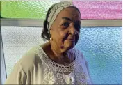  ?? ?? Lucia Barker, 83, a member of the choir at First Baptist Church on Colombia’s San Andres Island poses for a portrait in front of stained-glass windows on Aug. 18. “This church is my life,” Barker says of the sanctuary where she was baptized, married and worshipped for seven decades.