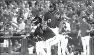  ?? AP/PATRICK SEMANSKY ?? Washington Nationals’ Kurt Suzuki (bottom) gestures after scoring in front of teammate Howie Kendrick on Gerardo Parra’s double on Friday in the second inning against the Cleveland Indians in Washington.