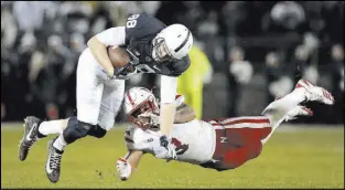  ?? Chris Knight The Associated Press ?? Nebraska linebacker Marcus Newby trips Penn State tight end Mike Gesicki in the first half of the No. 13 Nittany Lions’ 56-44 victory Saturday.