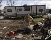  ?? MADDIE MCGARVEY — THE NEW YORK TIMES ?? Amber Emrick helps clean up debris left in aftermath of a tornado at a trailer park in Lakeview, Ohio, Friday.