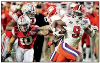  ?? (AP/Rick Scuteri) ?? Clemson running back Travis Etienne (right) runs for a touchdown against Ohio State during the second half of the Fiesta Bowl on Saturday in Glendale, Ariz. Etienne also had two touchdown receptions in the Tigers’ 29-23 victory.