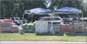  ?? JUSTIN RANSOM — THE NEWS-HERALD ?? Cars begin to fill the Miracle Revival Church parking lot as the church reopens its produce day for the first time since the pandemic began. On the fourth Thursday of each month, the church gives away fresh produce.