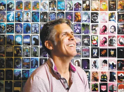 ?? LAURA A. ODA — STAFF ?? Niantic Chief Technology Officer Phil Keslin poses with a wall of fan-created Pokémon cards at the company’s office in San Francisco. Keslin is one of the creators of Pokémon Go.