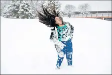  ?? MARLA BROSE/JOURNAL ?? ABOVE: Marissa Olivas, 11, flings her hair while playing in the snow with friends and family at Jerry Cline Park on Saturday.