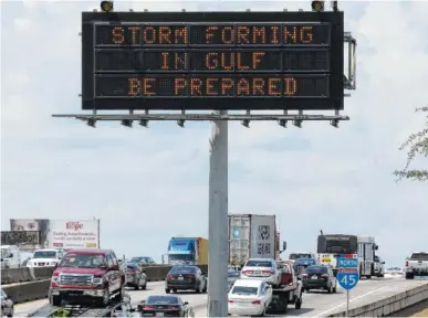  ?? THE ASSOCIATED PRESS ?? Motorists in Houston pass a sign warning of Hurricane Harvey as the storm intensifie­s in the Gulf of Mexico on Thursday. Harvey is forecast to be a major hurricane when it makes landfall along the middle Texas coastline later today.