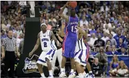  ?? MARK HUMPHREY — THE ASSOCIATED PRESS ?? Kansas’ Mario Chalmers shoots a three pointer to take the game in to overtime against Memphis on April 7, 2008.