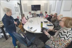  ?? Flip Putthoff/NWA Democrat-Gazette ?? Pat Kirby (left) starts a book club meeting.