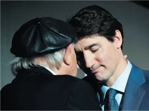  ?? NATHAN DENETTE / THE CANADIAN PRESS ?? Holocaust survivor Nate Leipciger shares a moment with Prime Minister Justin Trudeau on Tuesday after the PM delivered remarks at the March of Living 30th anniversar­y gala in Toronto.