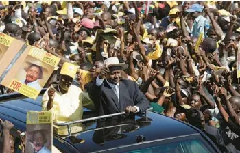  ?? ALEXANDER JOE/GETTY-AFP ?? Ugandan President Yoweri Kaguta Museveni greets supporters as he and his wife, Janet, arrive at a final election rally in Kampala in 2006. Museveni, now 78, has served as the nation’s president for 37 years and is in his sixth term.