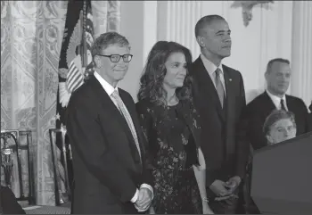  ?? OLIVIER DOULIERY/ABACA PRESS ?? U.S. President Barack Obama presents Bill and Melinda Gates with the Presidenti­al Medal of Freedom, the nation’s highest civilian honor, during a ceremony on Tuesday, honoring 21 recipients in the East Room of the White House in Washington, D.C.