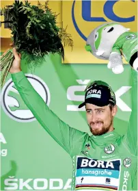  ??  ?? Slovakia's Peter Sagan, wearing the best sprinter's green jersey, celebrates on the podium after winning the 13th stage of the 105th edition of the Tour de France - AFP