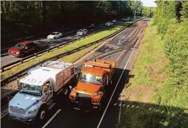  ?? Ned Gerard/Hearst Connecticu­t Media ?? Department of Transporta­tion trucks depart the scene of a wrong-way crash on Route 15 in Stratford Thursday morning.