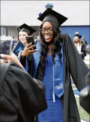  ?? BOB ANDRES / BANDRES@AJC.COM ?? To help more students achieve success, like these recent Georgia State University graduates, more help is needed from beyond school walls.