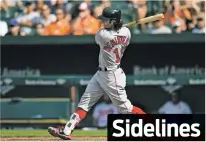  ?? GAIL BURTON/THE ASSOCIATED PRESS ?? Boston Red Sox’s Andrew Benintendi follows through on a single against the Baltimore Orioles in the ninth inning of Sunday’s game in Baltimore.