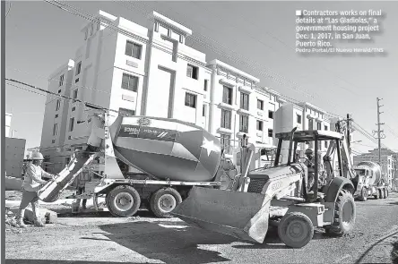  ?? Pedro Portal/El Nuevo Herald/TNS ?? ■ Contractor­s works on final details at “Las Gladiolas,” a government housing project Dec. 1, 2017, in San Juan, Puerto Rico.