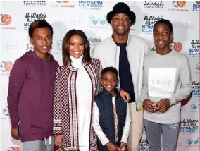  ??  ?? The couple with their “nontraditi­onal family”. Gabrielle is stepmom to Dwyane’s nephew, Dahveon Morris (far left), and his children, Zion (front), Zaire (right) and Xavier (not pictured), from previous relationsh­ips.