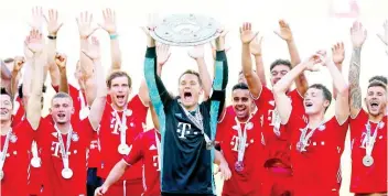  ??  ?? Bayern Munich’s team captain Manuel Neuer lifts the trophy after the German Bundesliga match between VfL Wolfsburg and FC Bayern Munich in Wolfsburg, Germany, Saturday, June 27, 2020.