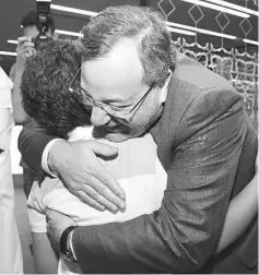  ??  ?? Ahmed Mansour hugs his son Mohammed after arriving at Hamad Airport in Doha. — AFP photo