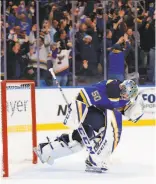  ?? Dilip Vishwanat / Getty Images ?? Goalie Jordan Binnington celebrates the Blues’ overtime victory over Toronto for a franchise-record 11th straight win.