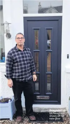  ??  ?? Delighted Mr McNaughton shows off his new door