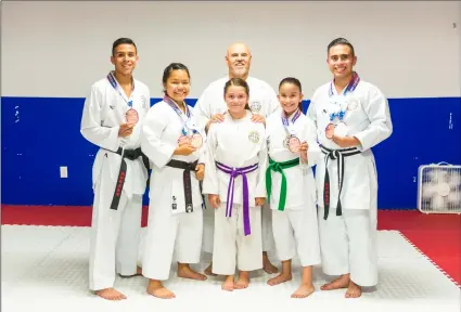  ?? VINCENT OSUNA PHOTO ?? FRROM LEFT: Julio Romero, 16, Zianya Louie, 15, shihan Ruben Canedo (top, middle), isabella neujahr, 9, nalani ibarra, 8, and Leonardo Castro, 22, of seiden Kai in Calexico pose on Tuesday with their medals won from the 2018 usa Karate national...