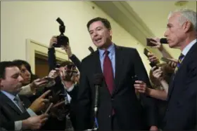  ?? SUSAN WALSH — THE ASSOCIATED PRESS ?? Former FBI Director James Comey, center, standing with his attornery David Kelley, right, speaks to reporters on Capitol Hill in Washington, Friday following his appearance before a closed-door hearing with the House Judiciary and House Oversight committees.