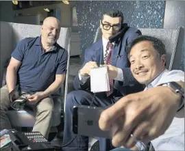  ?? Robert Gauthier
Los Angeles Times ?? DC COMICS co-publishers Dan DiDio, left, and Jim Lee take a selfie with a faux Clark Kent, known as a mild-mannered guy, at the company’s new Burbank home.