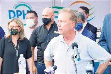  ?? Peter Yankowski / Hearst Connecticu­t Media ?? Gov. Ned Lamont speaks outside the CTown grocery store on North Street in Danbury late last month.