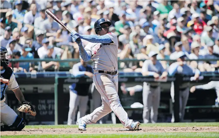  ?? — THE ASSOCIATED PRESS ?? Red Sox slugger Rafael Devers smacks a three-run home run against Mariners starter Mike Leake on Sunday in Seattle. The Red Sox were 9-3 winners.