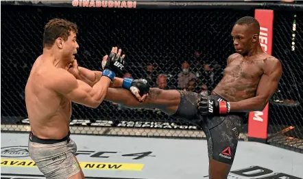  ?? GETTY IMAGES ?? Israel Adesanya, right, aims a kick at Paulo Costa during his emphatic win in UFC 253 in Abu Dhabi.