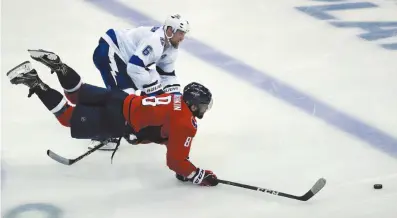  ?? AP PHOTO ?? Washington Capitals left wing Alex Ovechkin lunges for the puck as Tampa Bay Lightning defenseman Anton Stralman defends during Game 6 of the NHL Eastern Conference final series on Monday in Washington. The Capitals won 3-0.