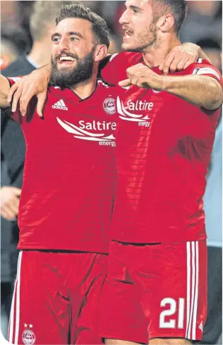  ??  ?? Aberdeen skipper Graeme Shinnie celebrates last Sunday’s Betfred Cup semi-final victory over Rangers with team-mate Dom Ball