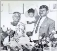  ??  ?? The author’s grandmothe­r, Kanniamma Govindaraj­ulu, and his father, Chungelrio­n Swaminatha­n Naidoo, carrying him on this first birthday. Family portraits have consistent­ly hung on the walls of their homes.