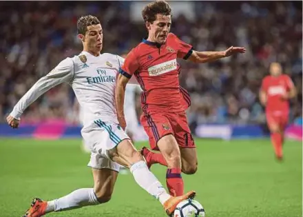  ?? EPA PIC ?? Real Madrid’s Cristiano Ronaldo (left) challenges Real Sociedad’s Alvaro Odriozola at the Santiago Bernabeu on Saturday.